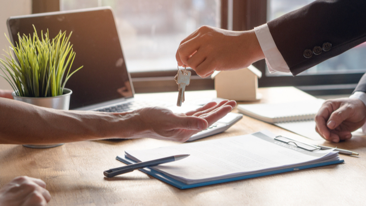 real estate agent handing over house keys